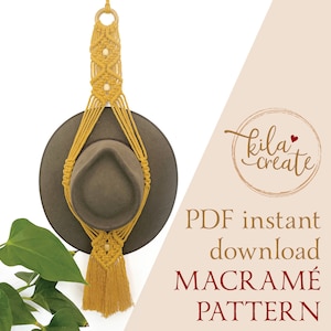 May include: A mustard yellow macrame hat hanger with a wooden ring at the top and a tassel at the bottom. The hanger is holding a brown hat. The image includes the text "Kila create" and "PDF instant download MACRAMÉ PATTERN".