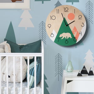 Modern rustic wall clock with a mountain and forest theme. Contemporary nature-inspired home decor, perfect for a nursery.