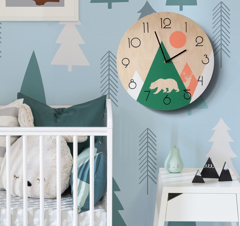 Modern rustic wall clock with a mountain and forest theme. Contemporary nature-inspired home decor, perfect for a nursery.