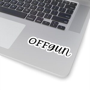 May include: A white laptop with a black sticker that says "OFFgun" on the top right corner of the laptop.