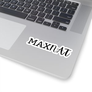 May include: A laptop computer with a sticker that says "MAXNAT" on the top right corner of the trackpad.