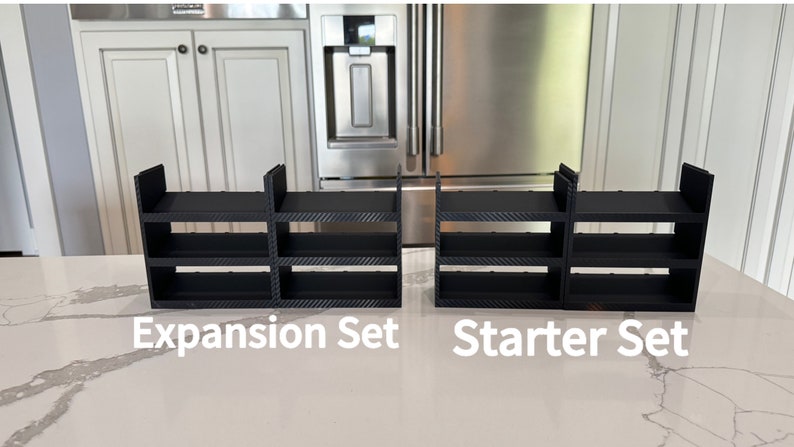 May include: Two black plastic shelf units, one labeled "Expansion Set" and the other labeled "Starter Set".