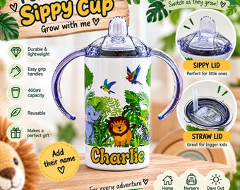 May include: A white sippy cup with two purple handles and a jungle animal print featuring a lion, elephant, and parrot. The name Charlie is printed in yellow. It includes a clear sippy lid and a straw lid, with a 400ml capacity label visible.