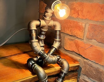 The Pensive Man industrial iron pipe man robot lamp