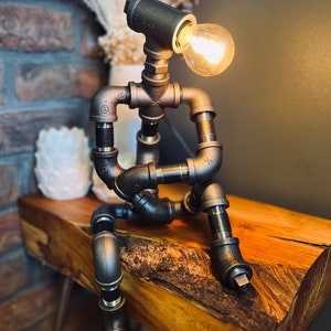 The Companion Industrial Iron Pipe Person Robot Lamp
