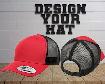 May include: Red and black trucker hat with a mesh back. The hat has a flat brim and a snap closure. The text "DESIGN YOUR HAT" is visible in the background.