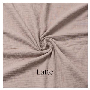 May include: A close-up of a swatch of fabric in a latte color. The fabric is gathered in a swirl, showing its texture. The word "Latte" is printed in black at the bottom.