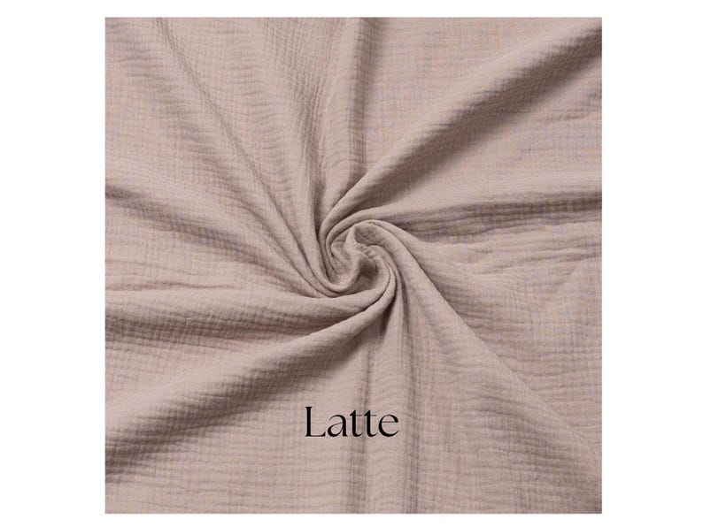 May include: A close-up of a swatch of fabric in a latte color. The fabric is gathered in a swirl, showing its texture. The word "Latte" is printed in black at the bottom.