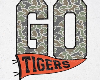 May include: A graphic design featuring the word "GO" in large, block letters with a camouflage pattern in shades of green, brown, and gray. Below, an orange pennant reads "TIGERS" in black. The design is suitable for apparel or accessories.