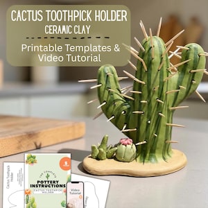 May include: A ceramic cactus toothpick holder with wooden toothpicks. The holder is green with dark green stripes and sits on a tan base. The image includes the text "Cactus Toothpick Holder Ceramic Clay Printable Templates & Video Tutorial."