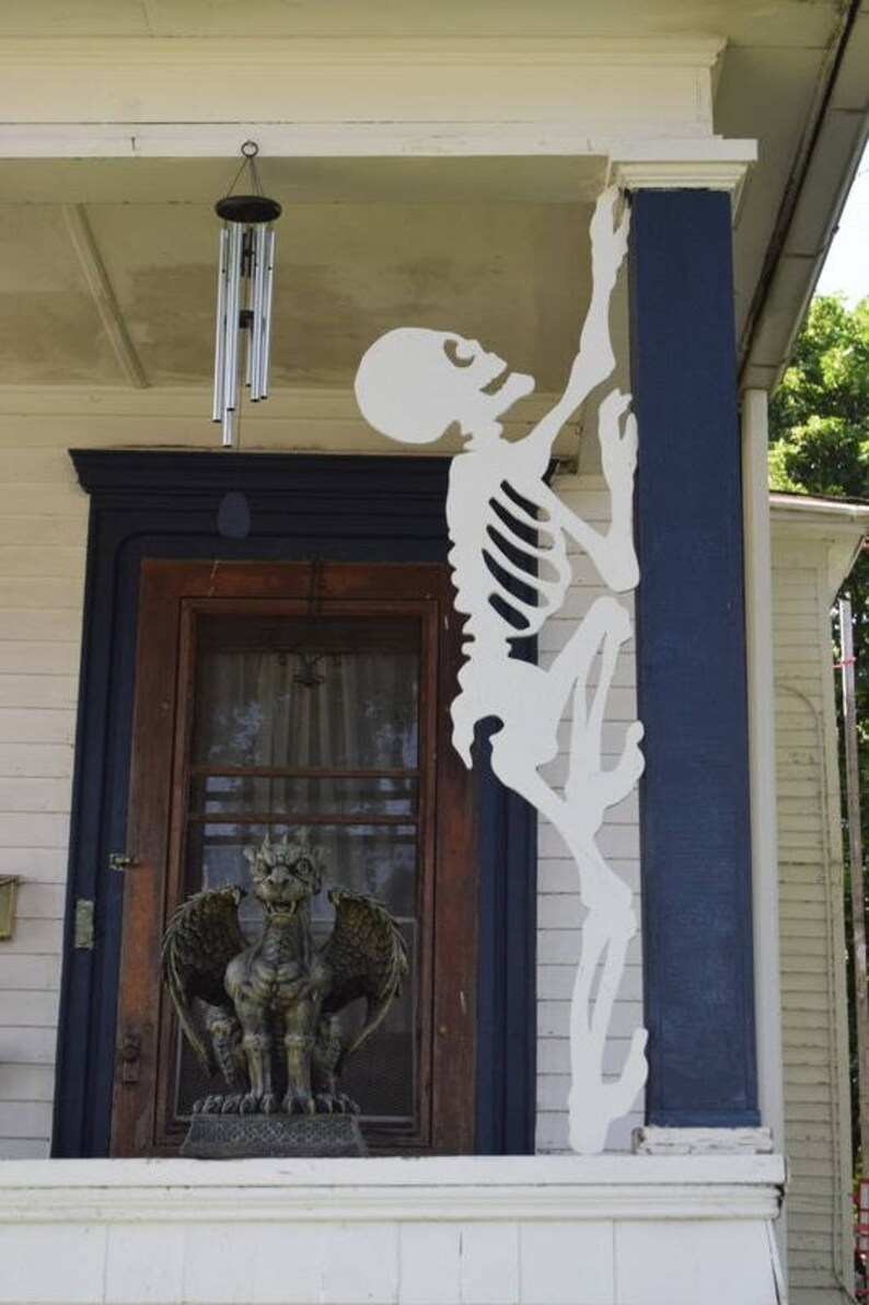 skeletons crawling up house skeletons crawling up house
