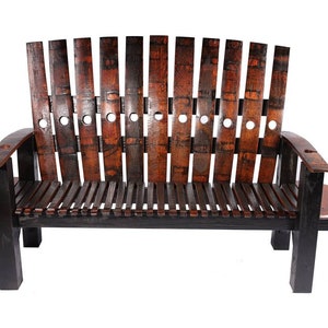 May include: A wooden bench made from repurposed wine barrels. The bench has a black frame and a curved backrest. The bench has two small side tables.