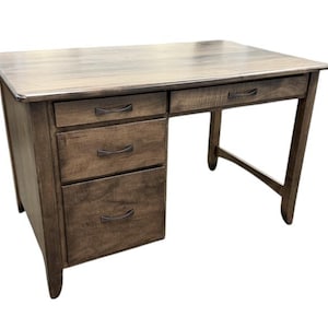 May include: A wooden desk with a warm brown finish. It features a rectangular top, three drawers on the left, and two drawers on the right. The desk has a classic design with curved drawer pulls and angled legs, suitable for a home office.