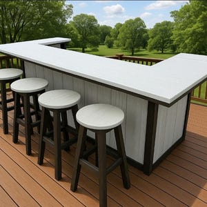 May include: An outdoor bar with a white countertop and a white and brown base. The bar is surrounded by several matching bar stools with white seats and brown legs. The bar is on a wooden deck with a green background.
