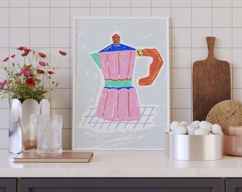 May include: A framed illustration of a pink and blue coffee pot with a white background. The illustration is on a white tiled countertop with a vase of red flowers, a glass of water, a wooden cutting board, a bowl of white rocks, and a pink bowl.