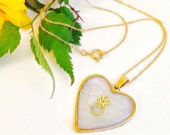 Gold necklace with resin heart and lotus flower pendant