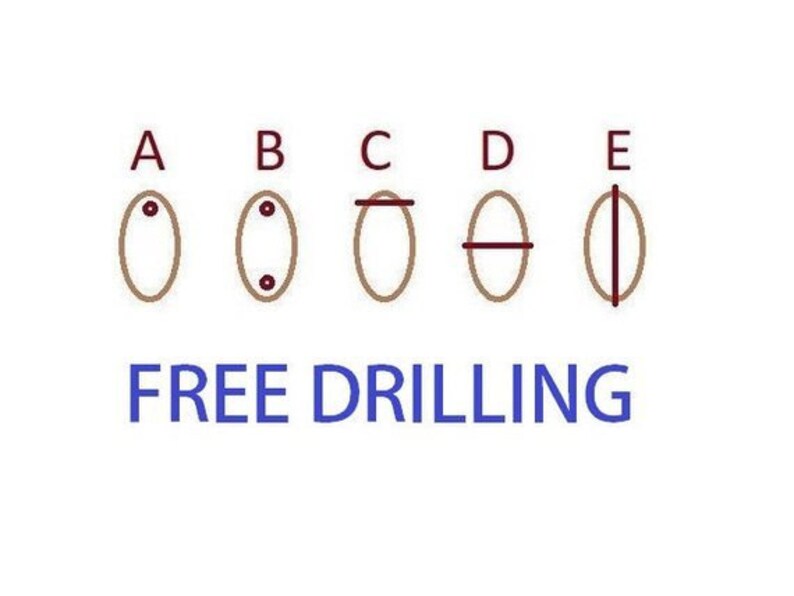 May include: Diagram illustrating five different drilling options for gemstones or beads. Each oval shape is labeled A through E, with different drilling patterns. The text "FREE DRILLING" is displayed in blue below the diagrams.