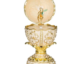 Caja de música con forma de huevo estilo Fabergé con figura de hada de 12,5 cm (5'') color crema