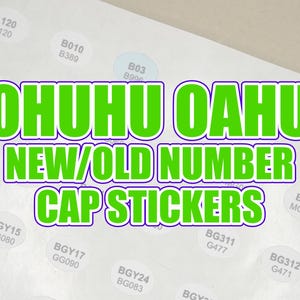 May include: Sheet of white stickers with black text and the words "OHUHU OAHU NEW/OLD NUMBER CAP STICKERS" in green and purple. The stickers are round and have numbers and letters.