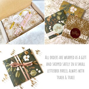 May include: A gift-wrapped parcel in a white box featuring gold floral tissue paper, a pink tag with the text with love, and a white thank you sticker. Other packages are wrapped in dark green botanical paper with ribbons and stickers.