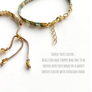 May include: Two bracelets featuring rectangular beads in green, gold, and white. One bracelet has a beige cord with a gold stopper bead, while the other features a gold lobster clasp and extension chain. Text reads: CHOOSE YOUR CLOSURE: BEIGE CORD AND STOPPER BEAD (HAS TO BE SHOVEN OVER YOUR HAND) OR A DAINTY LOBSTER CLOSURE WITH EXTENSION CHAIN.
