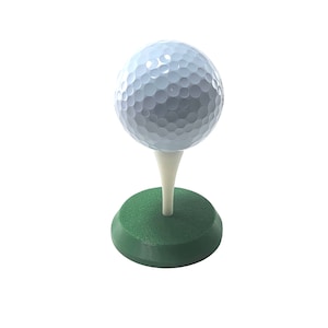 May include: A white golf ball on a green base with a white tee.
