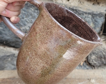 Red stoneware jug with shiny transparent enamel
