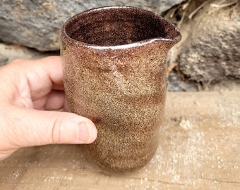 Small red stoneware jug with shiny transparent enamel inspired by japanese style