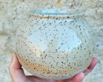 Small clay round vase mottled with black dots