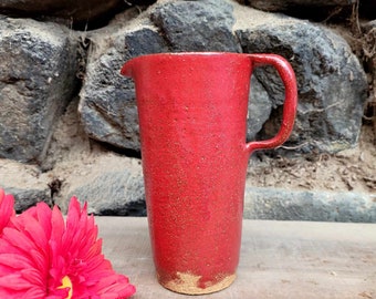 Red clay jug with red enamel