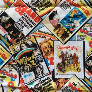 May include: A fabric design featuring multiple vintage movie posters for "The Wizard of Oz." The posters display Judy Garland, Frank Morgan, and Ray Bolger. The design incorporates bright colours and classic film imagery.