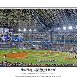 May include: Panoramic view of a baseball stadium during a game. The field is green with brown dirt areas. The stands are filled with fans wearing blue and white. The text "First Pitch - 2015 World Series" is visible at the bottom.