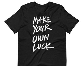 May include: Black t-shirt with white text that reads "MAKE YOUR OWN LUCK" in a bold, handwritten style.