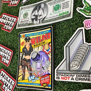 Op de afbeelding: Een comicboekomslag met een vrouw in politiekostuum en een lasser in een blauwe overall. De omslag is getiteld "Welder Magazine" en heeft bovenaan de tekst "Stackin' Dimes is a Crime!" De vrouw houdt een lasbrander vast en de lasser last een metalen constructie. De comicboekomslag is een sticker.