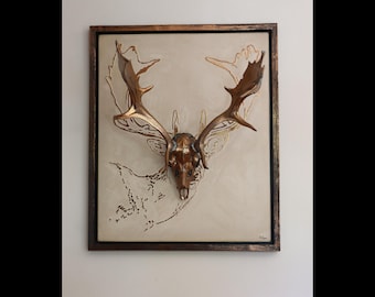 Painting with deerskull and antlers in a metallic old gold,painting with an embossed outline also in old gold, painting with combining frame