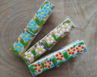 Set of three hand painted wooden clothespins with magnets in Petrykivka ukrainian folk painting style