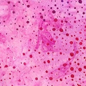 May include: A pink and white fabric with a scattered polka dot pattern. The dots are various shades of pink and red.