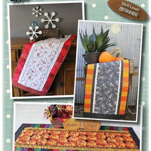 May include: A promotional image for a Fab-Focus Table Runner, 16.5 inches x 40.5 inches. The image shows three different table runner designs, including one with a pumpkin pattern and another with a red and white design. The skill level is beginner.