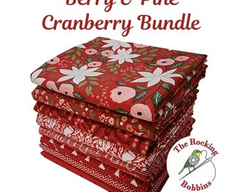 May include: A stack of red fabric bundles with floral and geometric patterns. The top fabric features white flowers and pink roses on a red background. The text "Berry & Pine Cranberry Bundle" is at the top. The logo for "The Rocking Bobbins" is in the bottom right.