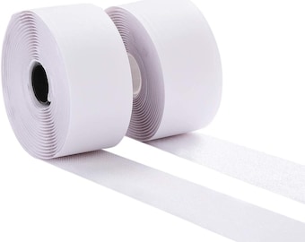 May include: Two rolls of white hook and loop tape, also known as Velcro, are shown. The tape is rolled up and the ends are attached to each other. The tape is used for attaching two pieces of fabric together.
