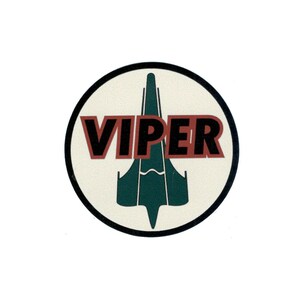 May include: A round, white sticker with a black outline. The sticker features a green spaceship with the word "VIPER" in red letters.