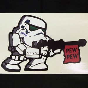 May include: A white and black cartoon illustration of a Stormtrooper holding a black blaster rifle with a red flag that says "PEW PEW".