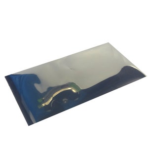May include: A rectangular, silver-colored, reflective pouch. The pouch is slightly transparent, with a subtle sheen. The edges are sealed, and the overall shape is flat, suggesting it is designed for packaging small items.