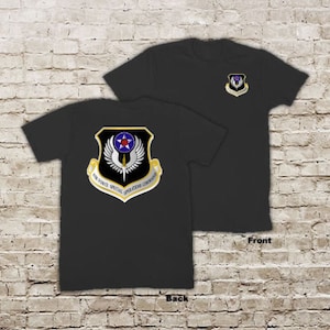 May include: Black t-shirt with a gold and blue Air Force Special Operations Command patch on the back and a smaller version of the patch on the front.
