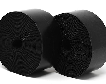 May include: Two rolls of black hook and loop fastener tape. The tape is rolled up and ready to be used for organizing cables or securing items.