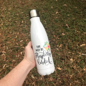 May include: White stainless steel water bottle with a floral design and the text "This may be Raspberry Cordial" printed on it.