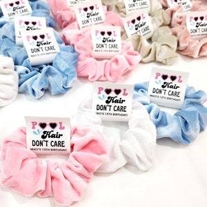 May include: A collection of colorful velvet scrunchies with white labels that say "Pool Hair Don't Care" and "Macy's 13th Birthday!"