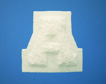 May include: White letter A made of a textured material, on a blue background.