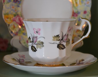 English Bone China Elizabethan Cup and Saucer with white background and gold trim, pedestal base and pink rose buds