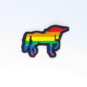May include: Rainbow unicorn iron-on patch. The unicorn is outlined in black and filled with the colors of the rainbow.